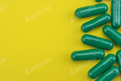 Preview: Some Capsules Greens Isolated On A Yellow Background, Conceptual Image
