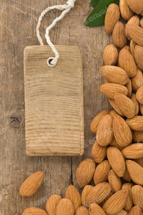Preview: Nuts Almond And Tag Price On Wood Background