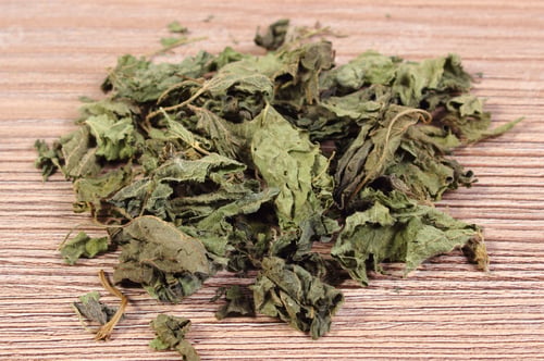 Preview: Heap Of Healthy Dried Nettle On Wooden Table, Concept For Healthy Nutrition And Herbalism