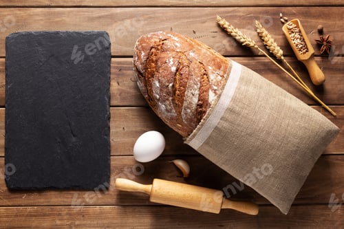 Preview: Loaf Of Fresh Bread And Bakery Ingredients For Homemade Baking On Wooden Table. Baker Food Set At