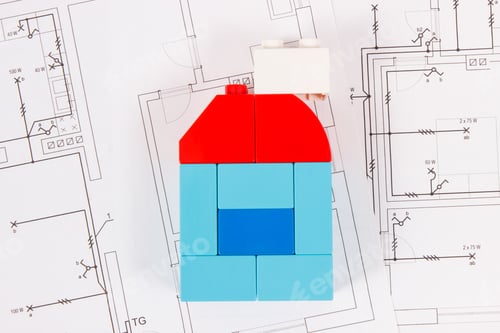Preview: Colorful Plastic Toy Blocks And Construction Drawings Of House. Concept Of Buying Or Renting Home