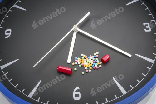 Preview: Open Red Capsule Pill With White Powder Drug On Black Clock Background