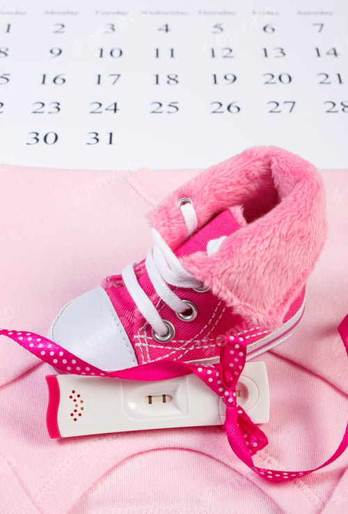 Preview: Pregnancy Test With Positive Result And Clothing For Newborn On Calendar, Baby Shoes, Bodysuits