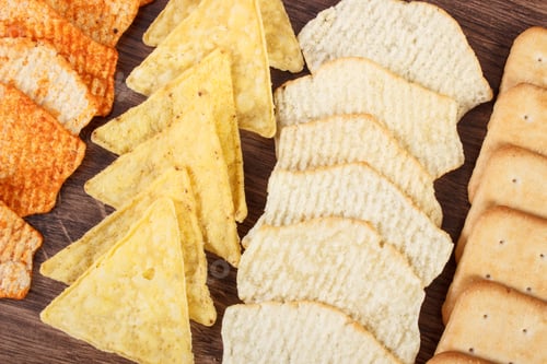 Preview: Crunchy Cookies And Salted Potato Crisps With Peppers On Rustic Board, Concept Of Restriction