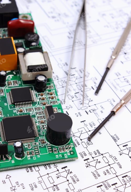 Preview: Printed Circuit Board With Electrical Components And Precision Tools Lying On Construction Drawing