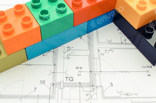 Preview: Wall Of Colorful Building Blocks Lying On Construction Drawing Of House. Building Home Concept
