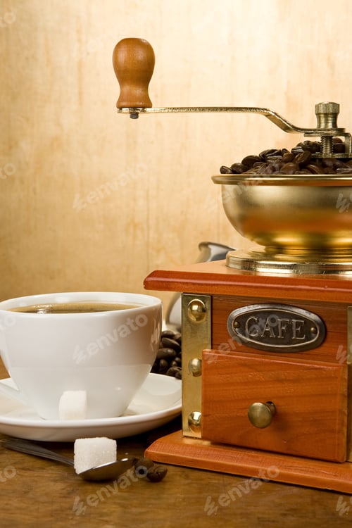 Preview: Cup Full Of Coffee, Beans, Pot And Grinder On Wood