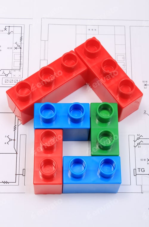 Preview: House Shape Of Colorful Plastic Building Blocks Lying On Construction Drawing Of House, Concept Of