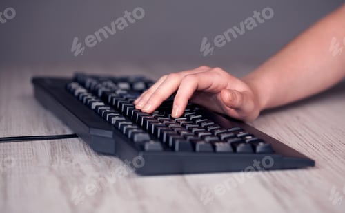Preview: Close Up Of Hand Pressing Keyboard Buttons On Desk