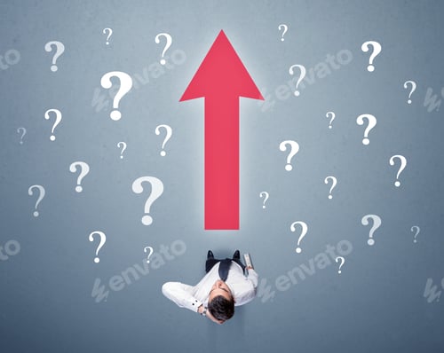 Preview: Young Contemplating Businessman Stands In Front Of A Big Red Arrow And White Question Marks