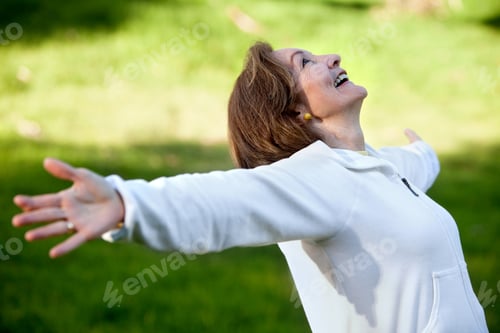 Preview: Happy Woman Enjoying The Wind Outdoors And Smiling