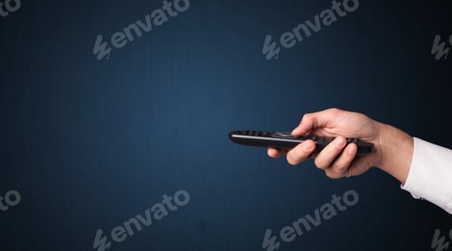 Preview: Hand Holding A Remote Control On Blue Background