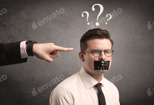 Preview: Caucasian Business Hand Pointing At Scared Employee With Big White Question Marks Above His Head