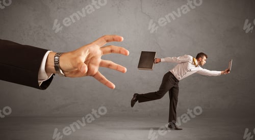 Preview: Young Miniature Businessman Running From A Big Hand With Grey Background