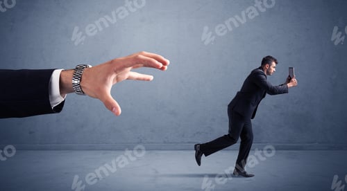 Preview: Young Miniature Businessman Running From A Big Hand With Blueish Background