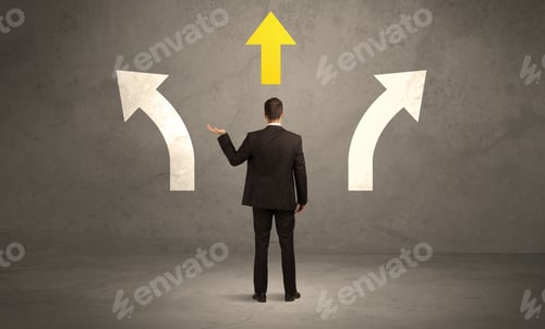 Preview: A Confused Businessman Facing A Grey Urban Wall With A Yellow Arrow Pointing In The Right Direction