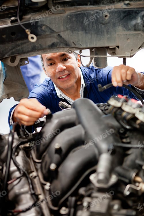 Preview: Male Mechanic Fixing A Broken Car At The Repair Shop