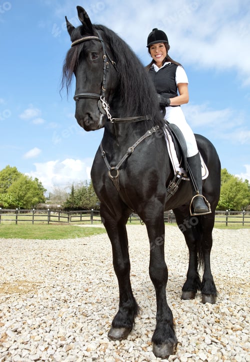Preview: Happy Female Jockey Riding A Horse Outdoors And Smiling