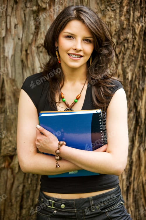 Preview: Beautiful Young Female Student With A Notebook Outdoors