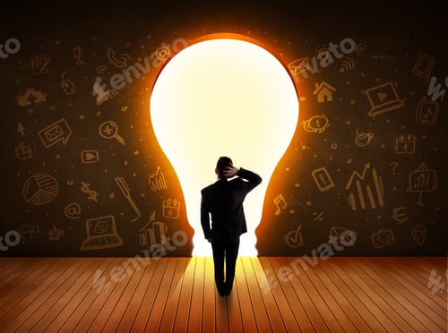 Preview: Business Man Looking At Bright Light Bulb In The Wall Concept
