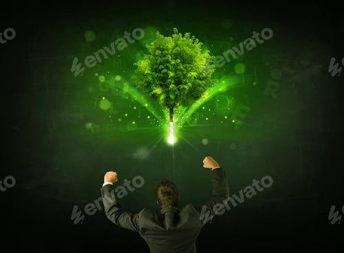 Preview: Young Businessman Standing With A Glowing Tree And Letters Above His Head