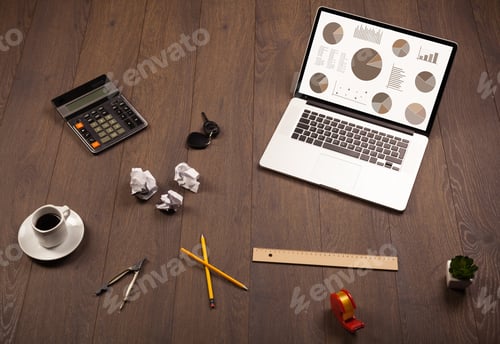 Preview: Pie Chart Graph Icons And Symbols On Laptop Screen With Office Accessories