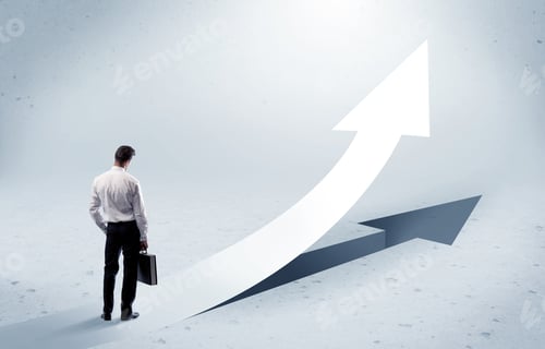 Preview: A Young Adult Salesman Standing In Front Of A Big Arrow Pointing Up With A Shadow In Grey Empty