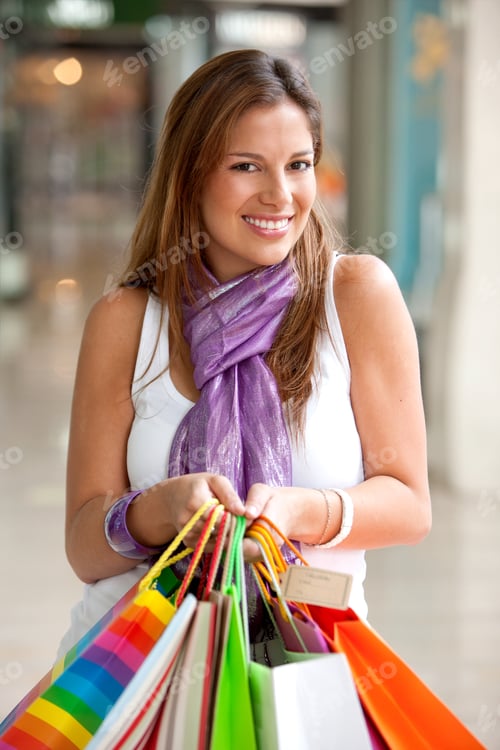Preview: Beautiful Girl Smiling With Shopping Bags In A Mall