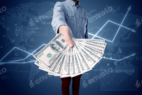Preview: Young Businessman Holding Large Amount Of Bills With Blue Charts In The Background