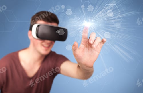 Preview: Young Impressed Man Wearing Virtual Reality Goggles With Blue Hexagons Around Him