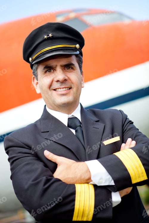 Preview: Confident Pilot Smiling With An Airplane At The Background