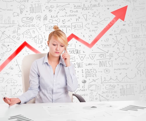 Preview: Business Woman Sitting At Table With Market Hand Drawn Diagrams