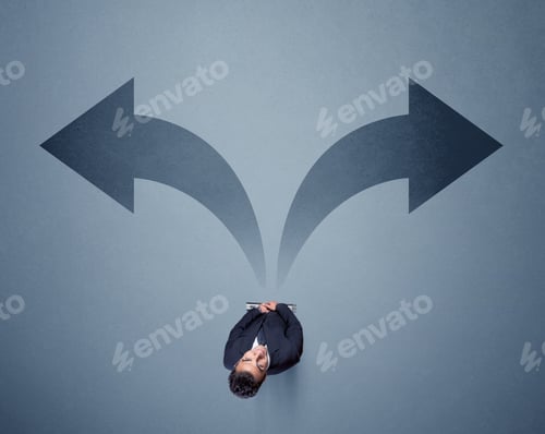 Preview: Young Smart Businessman Standing In Front Of Two Arrows Potinting To Different Ways Contemplating A