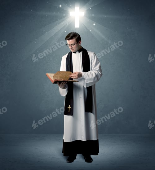 Preview: A Young Caucasian Priest With Deep Faith Blessing With The Holy Bible In His Hand In Front Of Blue