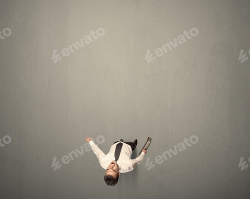 Preview: Young Businessman Contemplating A Decision Standing On A Grey Surface