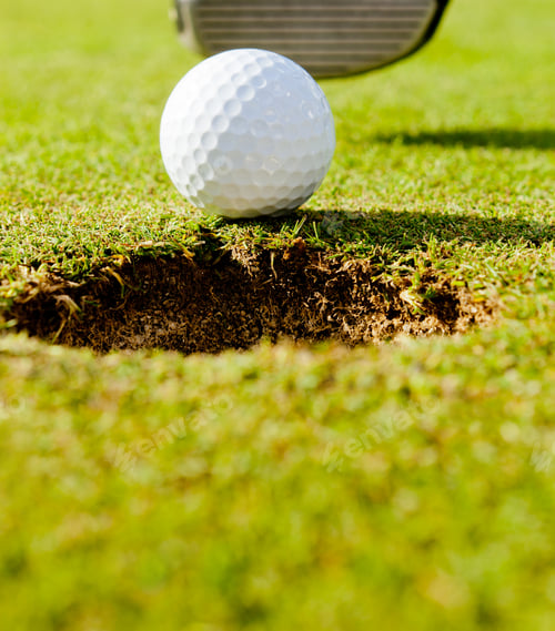 Preview: Golf Ball Going Into The Whole Over A Green Field