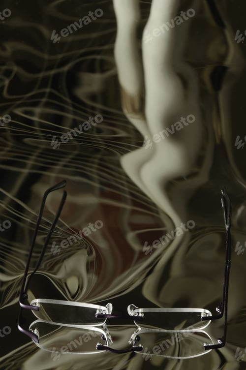 Preview: Illusion And Reality: Reading Glasses On Reflective Surface With Distorted Leading Lines