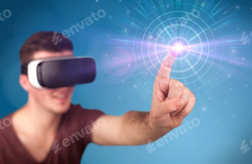 Preview: Young Impressed Man Wearing Virtual Reality Goggles With Blue Circles Around His Finger