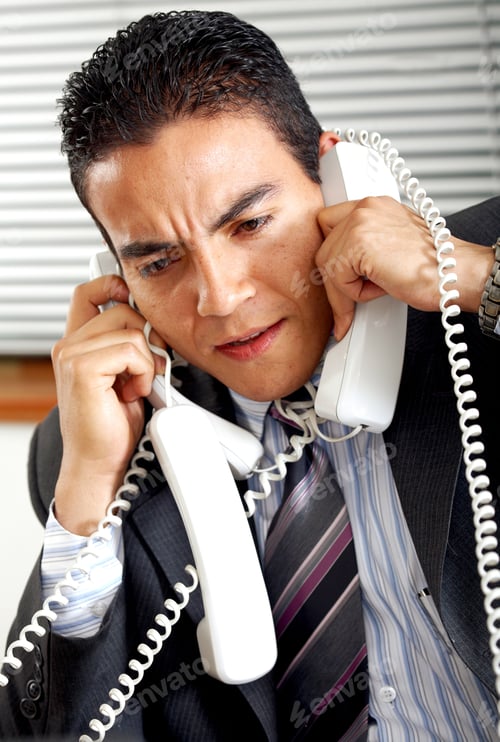 Preview: Busy Business Man With Many Telephones At Once