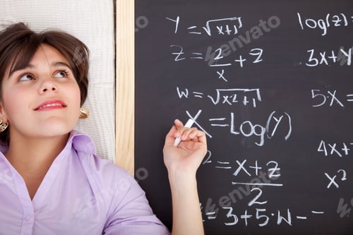 Preview: Beautiful Girl Writing Math Equations On A Chalkboard