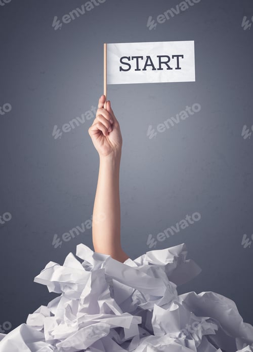 Preview: Female Hand Emerging From Crumpled Paper Pile Holding A White Flag With Start Written On It