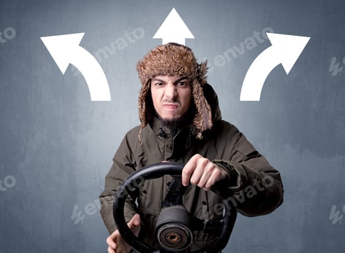 Preview: Young Man Holding Black Steering Wheel With Three Arrows Above His Head Pointing In Different