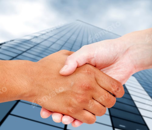 Preview: Close Up Of A Business Handshake With An Office Building Behind