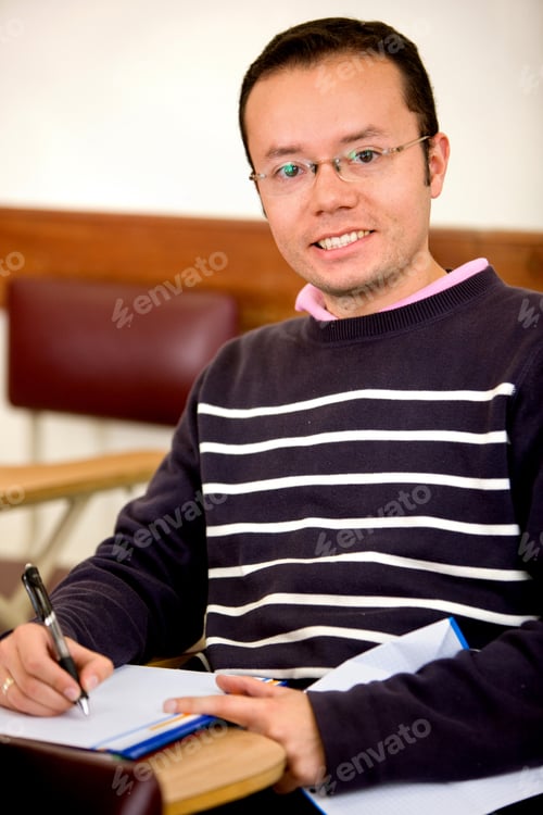Preview: Male Student With A Notebook Smiling Indoors