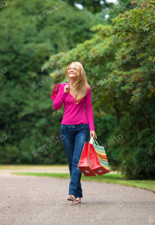 Preview: Happy Girl Walking With Bags At The Park
