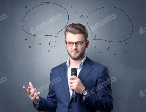 Preview: Businessman Speaking Into Microphone With Speech Bubbles Over His Head