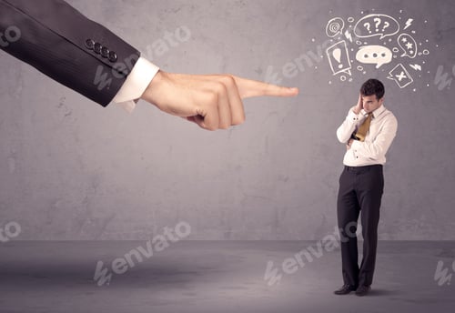 Preview: A Young Confused Businessman Being Fired By Large Boss Hand Concept With Drawn Speech Bubbles