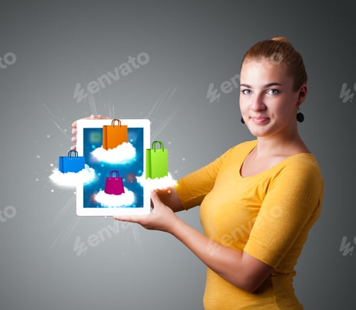 Preview: Beautiful Woman Holding Modern Tablet With Colorful Shopping Bags On Clouds