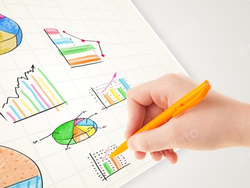 Preview: Business Person Drawing Colorful Graphs And Icons On Plain Paper