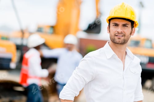 Preview: Male Engineer Working At A Construction Site And Wearing Helmet